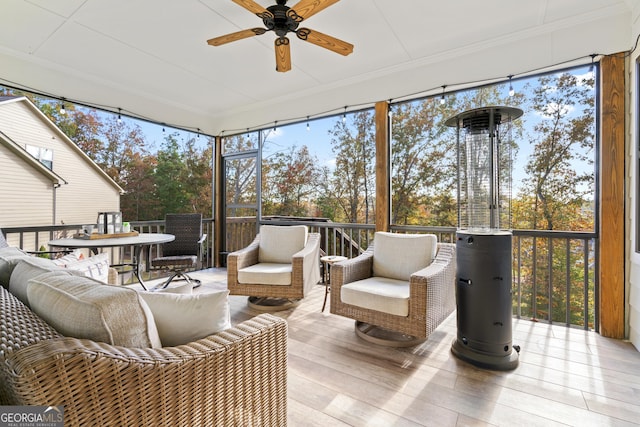sunroom featuring ceiling fan