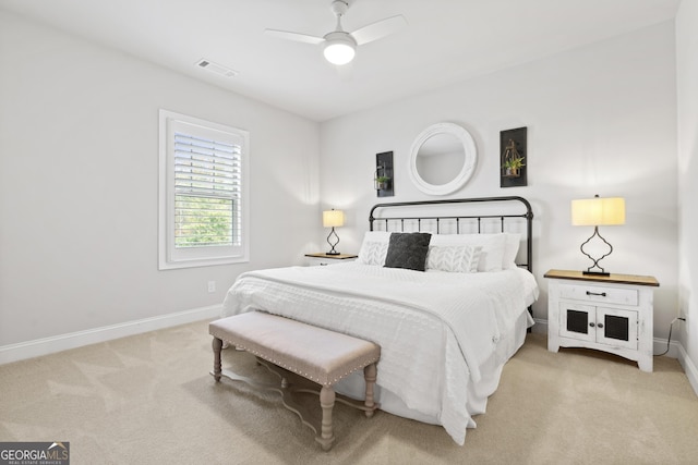 bedroom with light carpet and ceiling fan