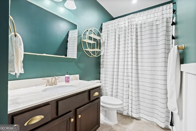 bathroom with vanity, toilet, tile patterned floors, and walk in shower