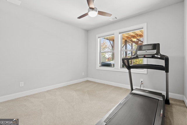 workout room with ceiling fan and carpet floors