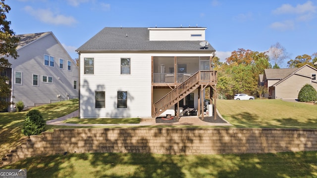 rear view of property with a sunroom and a lawn