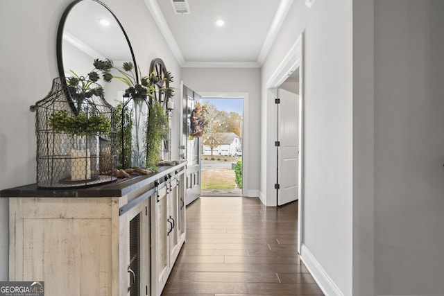 interior space featuring dark wood-type flooring and ornamental molding