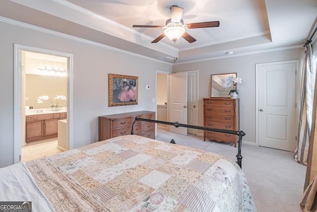 bedroom with light carpet, connected bathroom, ornamental molding, and a raised ceiling