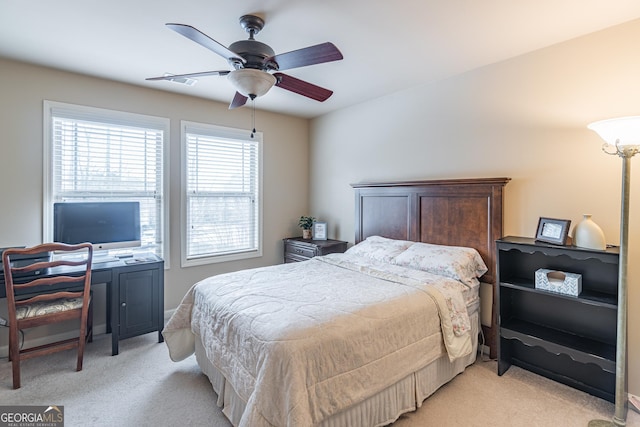 bedroom with ceiling fan and light carpet