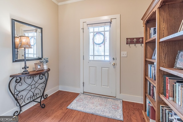 entryway featuring ornamental molding and hardwood / wood-style floors