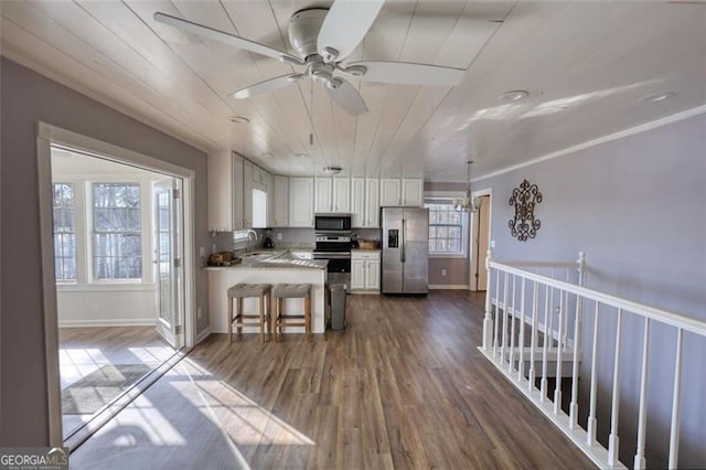 kitchen with wood ceiling, stainless steel appliances, dark hardwood / wood-style flooring, white cabinets, and sink