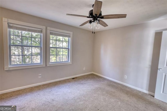 empty room featuring ceiling fan and carpet flooring