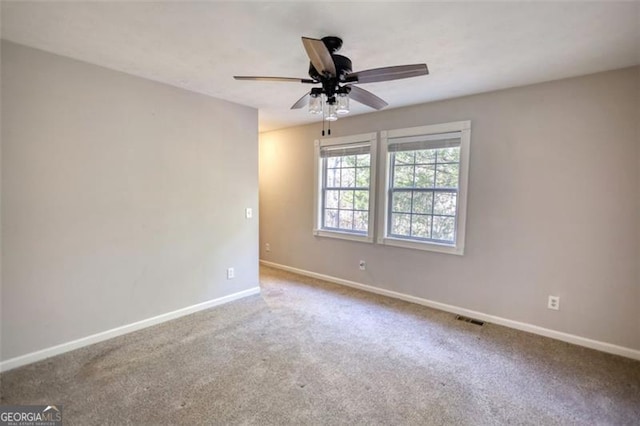 unfurnished room with ceiling fan and carpet floors