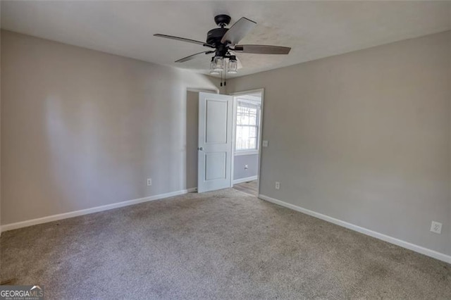 carpeted empty room featuring ceiling fan