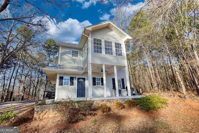 view of property featuring ceiling fan and a porch