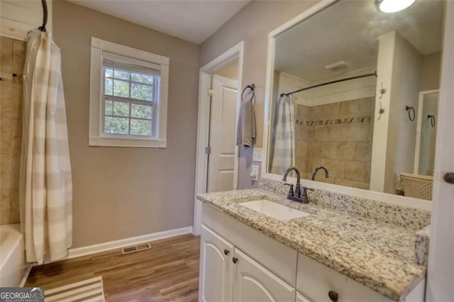 bathroom with vanity, wood-type flooring, and shower / bath combination with curtain