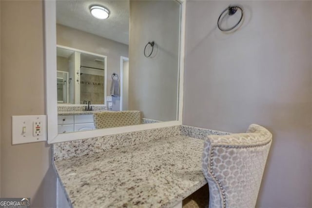 bathroom with a textured ceiling and vanity