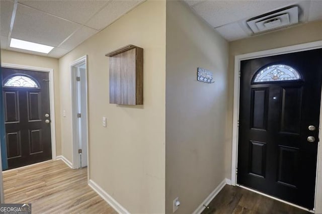 entryway featuring a paneled ceiling and hardwood / wood-style flooring