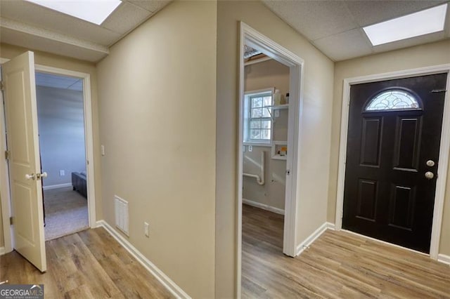 foyer entrance featuring a paneled ceiling and light hardwood / wood-style flooring