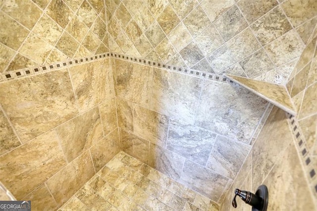 interior details with a tile shower