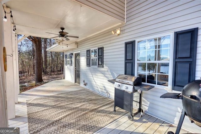 deck featuring ceiling fan and a grill