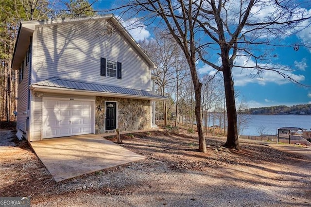 view of front of home with a water view and a garage