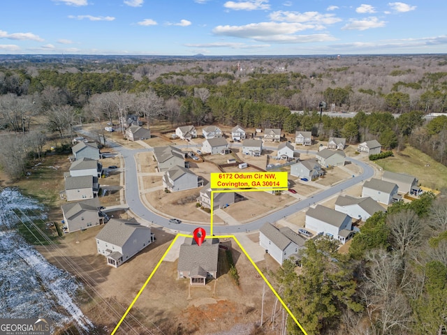 aerial view featuring a wooded view and a residential view