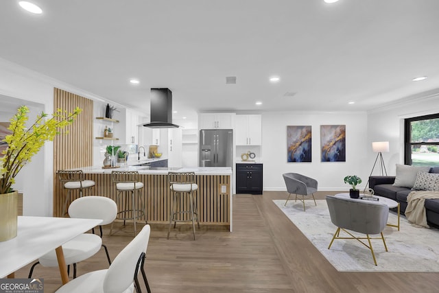 interior space featuring light hardwood / wood-style floors, sink, and ornamental molding