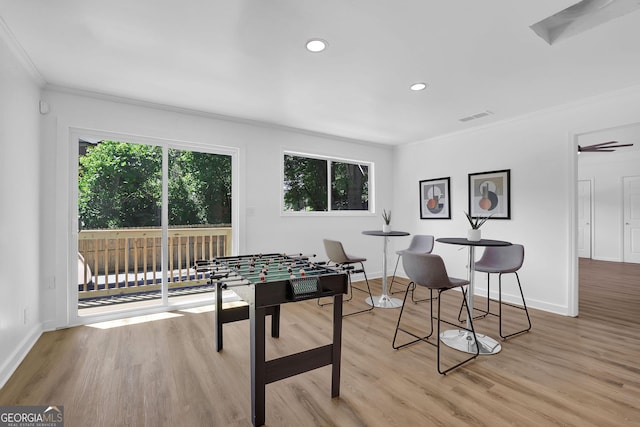 game room featuring crown molding and light hardwood / wood-style floors