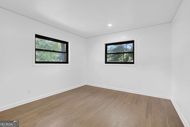 unfurnished room with wood-type flooring