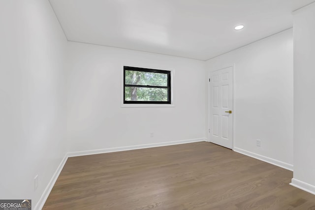 spare room featuring dark wood-type flooring