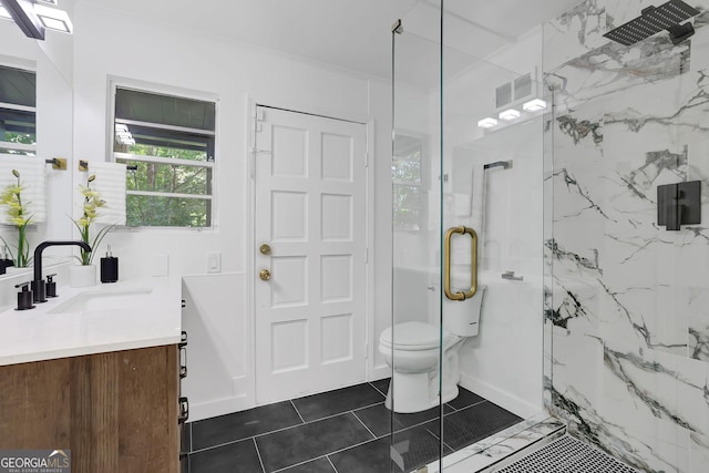 bathroom with toilet, a shower with door, tile patterned flooring, ornamental molding, and vanity