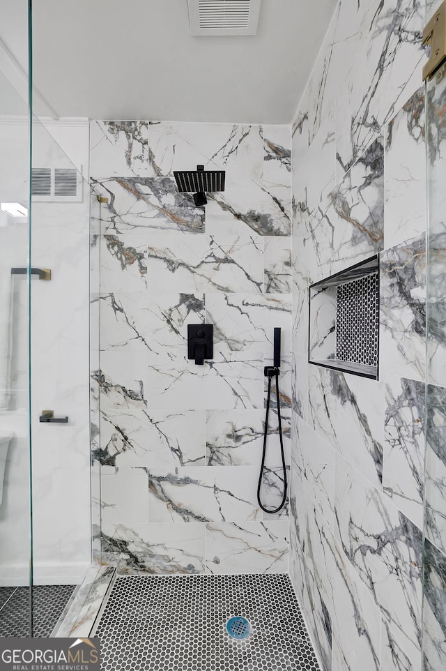 bathroom with a tile shower