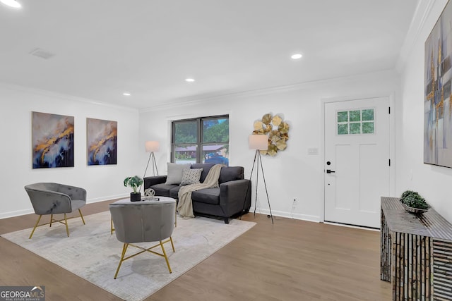 living room with plenty of natural light, ornamental molding, and light wood-type flooring