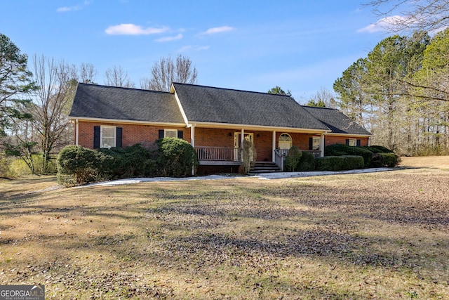 single story home with covered porch and a front yard