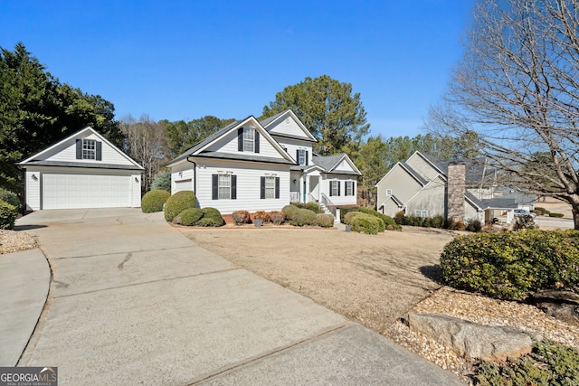 view of front of home featuring a garage and an outbuilding