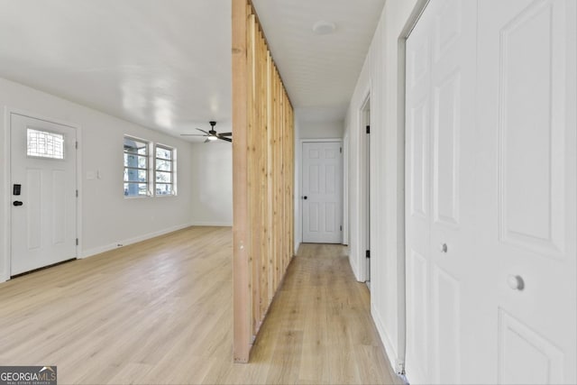 hallway with light hardwood / wood-style flooring