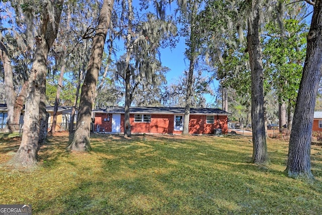 rear view of property with a yard