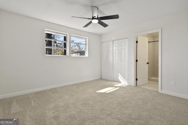 unfurnished bedroom with ceiling fan, light colored carpet, connected bathroom, and a closet