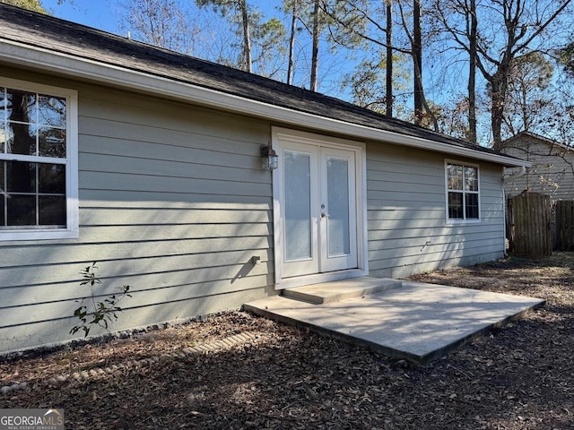 view of exterior entry with a patio area and french doors