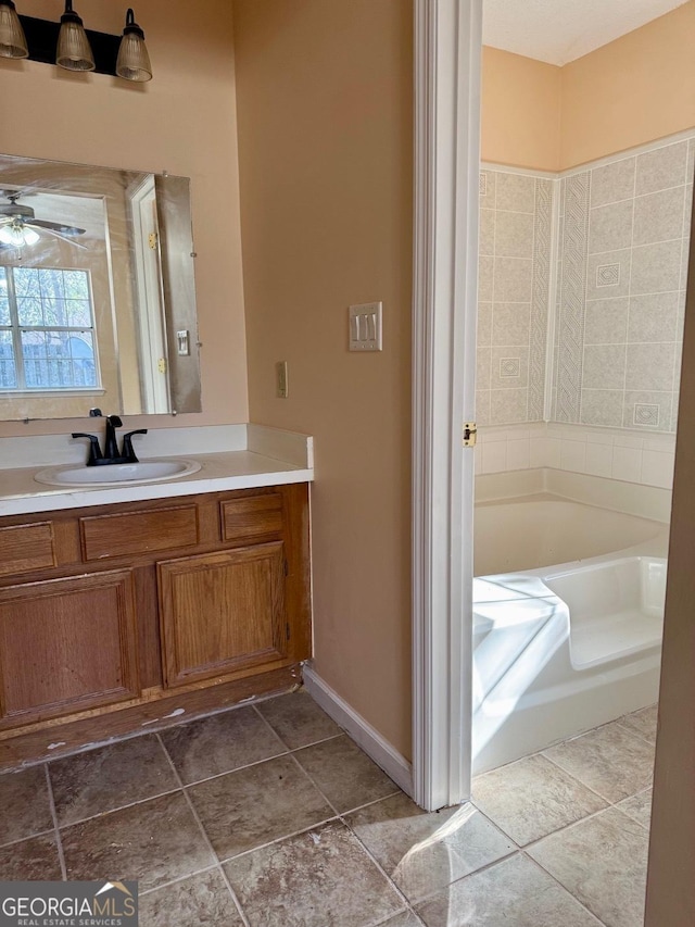 bathroom with vanity, ceiling fan, and a bathing tub