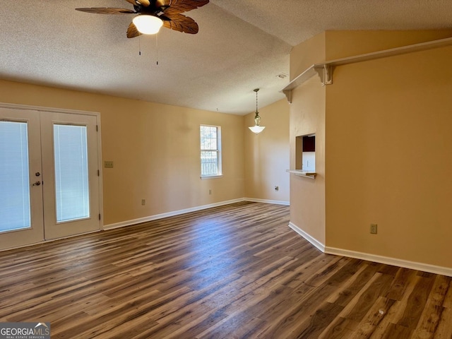 spare room with ceiling fan, lofted ceiling, a textured ceiling, and dark hardwood / wood-style flooring