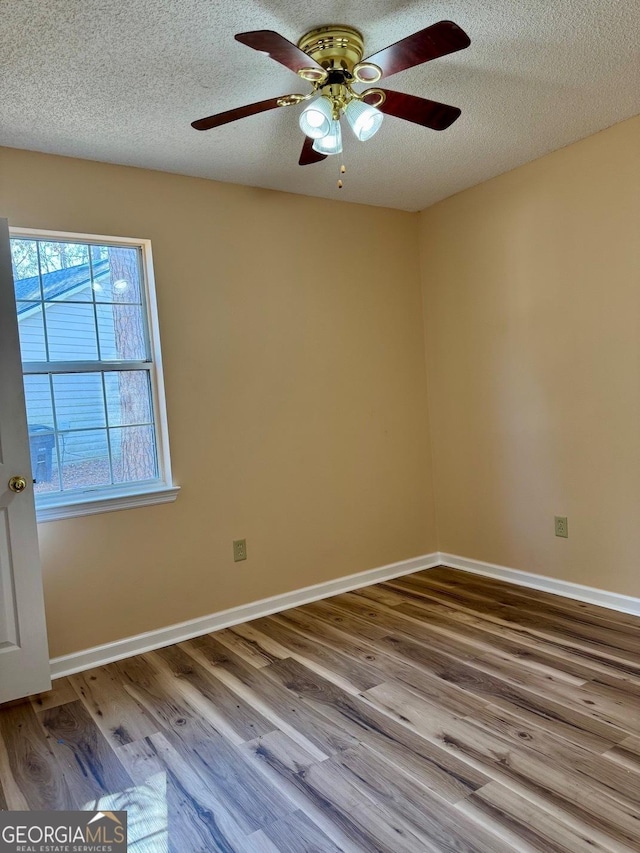 unfurnished room with ceiling fan, light hardwood / wood-style flooring, and a textured ceiling