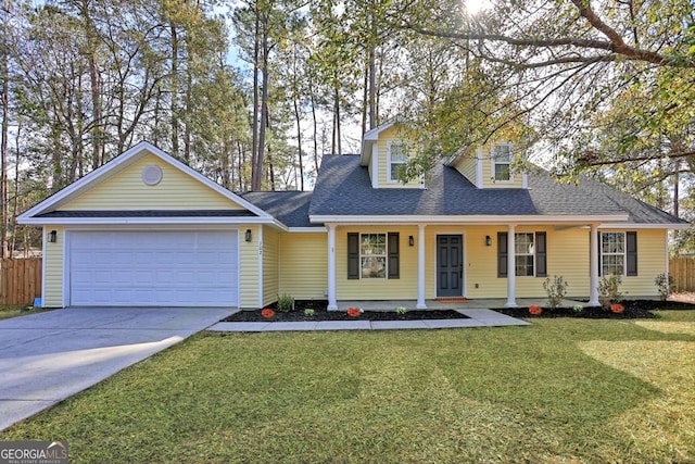 view of front of house featuring a front yard, covered porch, and a garage