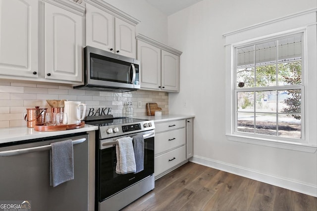 kitchen with decorative backsplash, white cabinetry, and appliances with stainless steel finishes