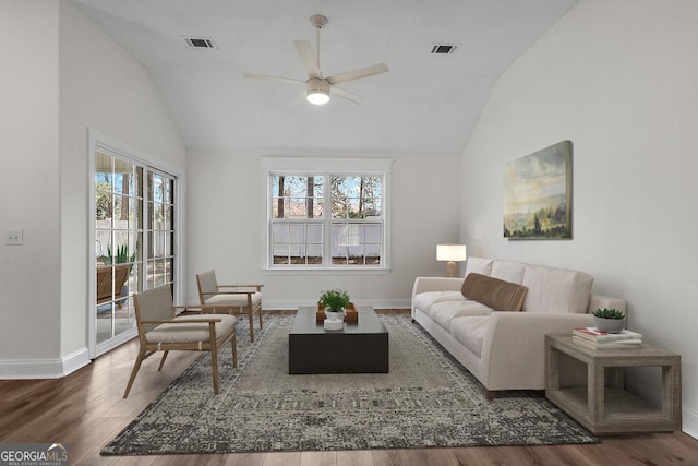 living room with ceiling fan, dark hardwood / wood-style flooring, and vaulted ceiling