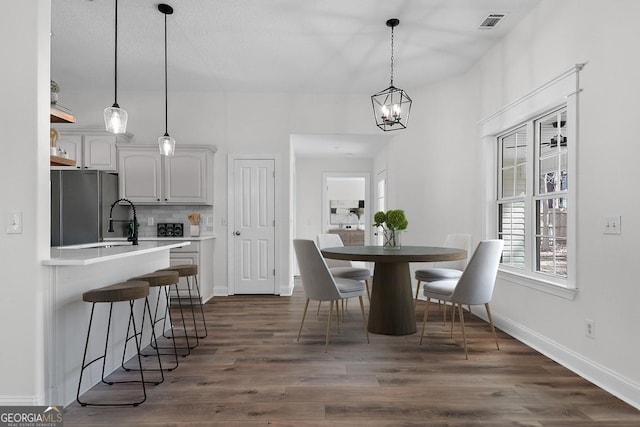 dining room featuring dark hardwood / wood-style flooring and a chandelier