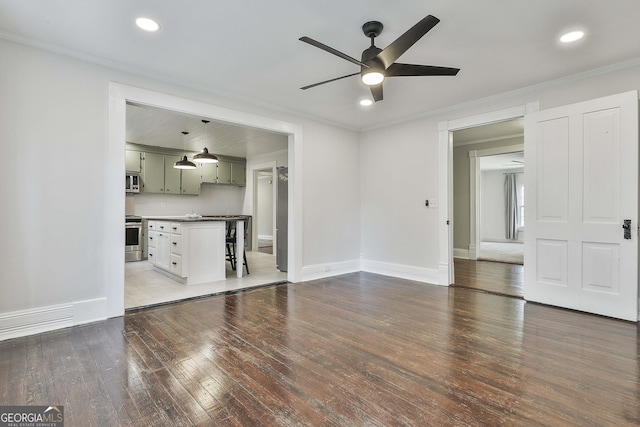 unfurnished living room with ceiling fan, dark hardwood / wood-style flooring, and ornamental molding