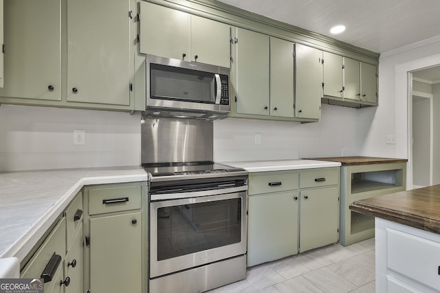 kitchen with green cabinets, appliances with stainless steel finishes, and ornamental molding