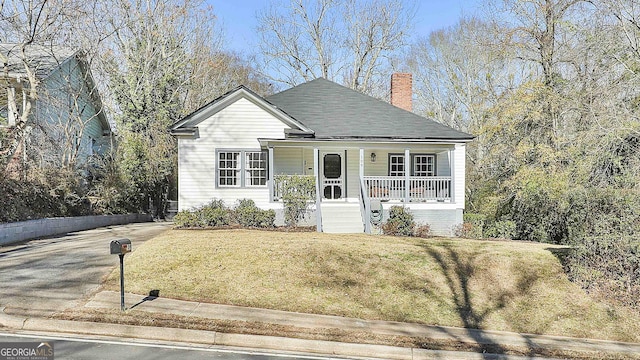 view of front of house featuring a front yard and covered porch