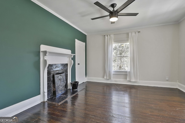 unfurnished living room featuring a premium fireplace, ceiling fan, dark hardwood / wood-style flooring, and crown molding