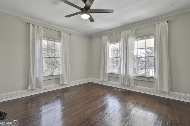 spare room featuring ceiling fan, dark wood-type flooring, and crown molding