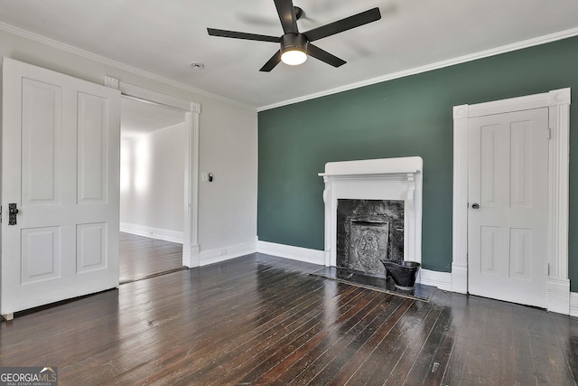 unfurnished living room featuring a premium fireplace, ceiling fan, ornamental molding, and dark hardwood / wood-style floors