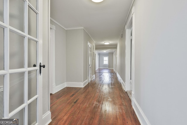 hallway featuring dark wood-type flooring and ornamental molding