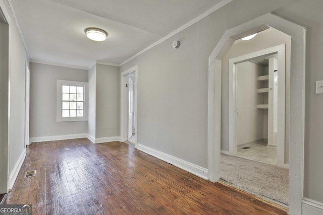 spare room featuring light hardwood / wood-style flooring and ornamental molding